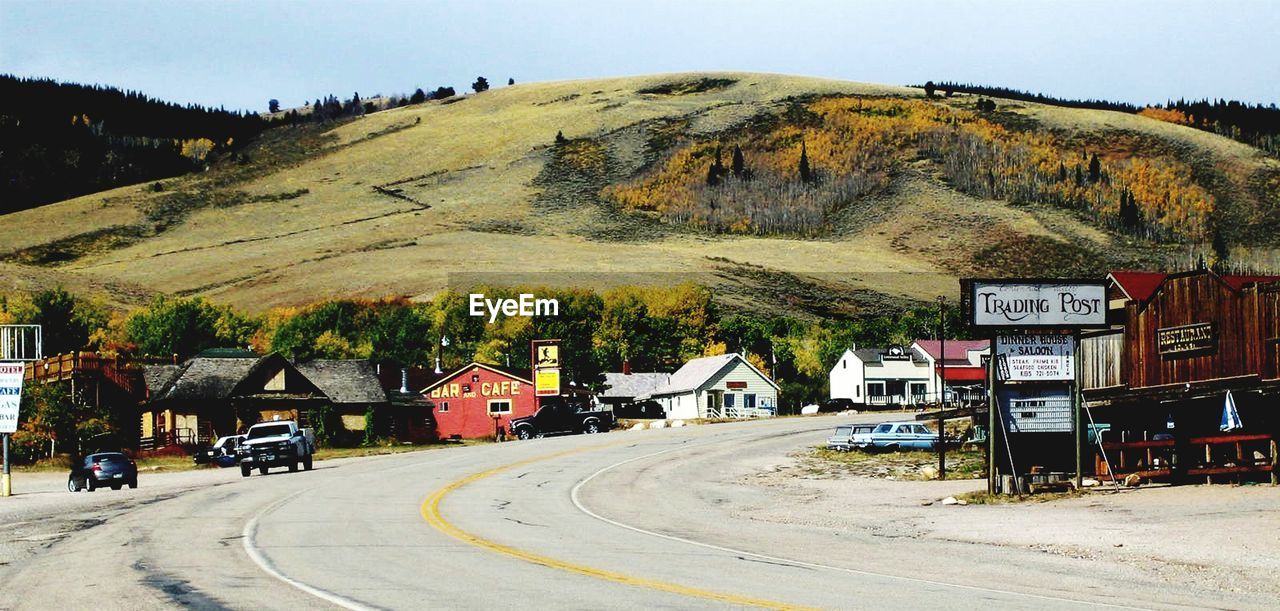 ROAD BY BUILDING AGAINST SKY