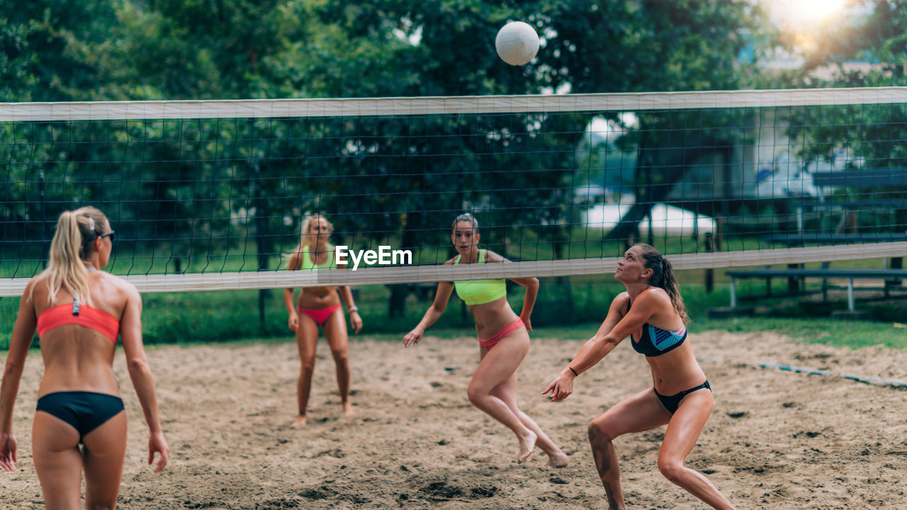 Young women playing beach volleyball