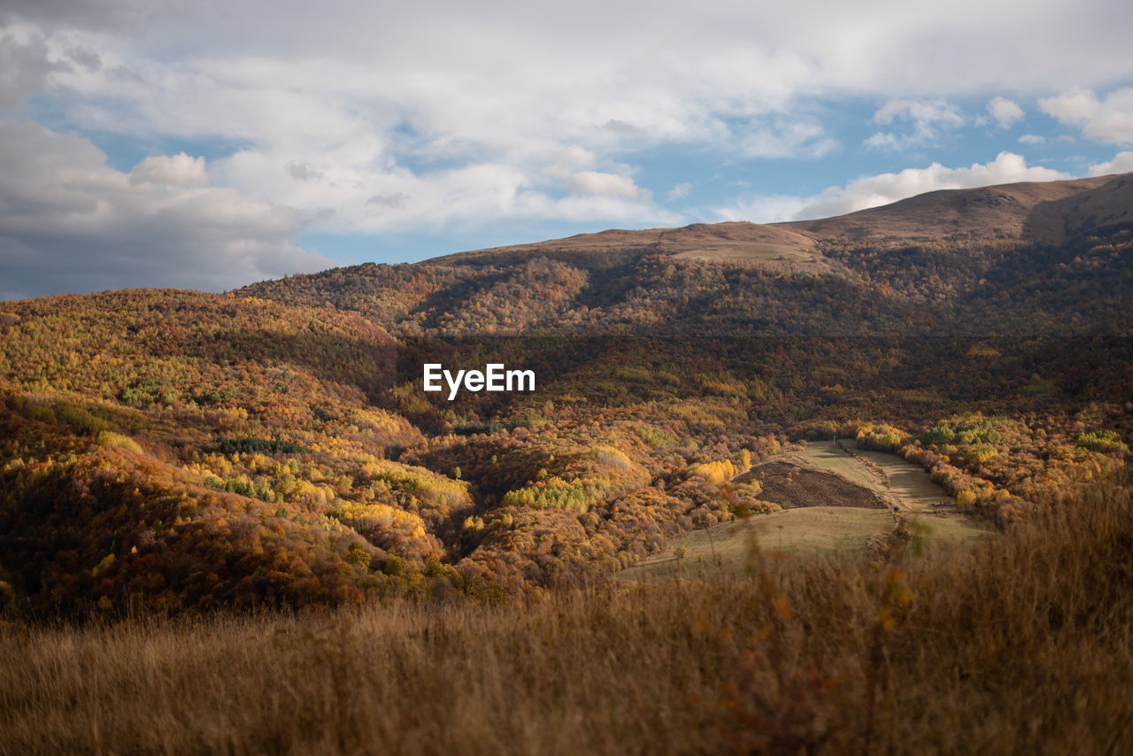 Scenic view of autumn landscape of mountains against the sky