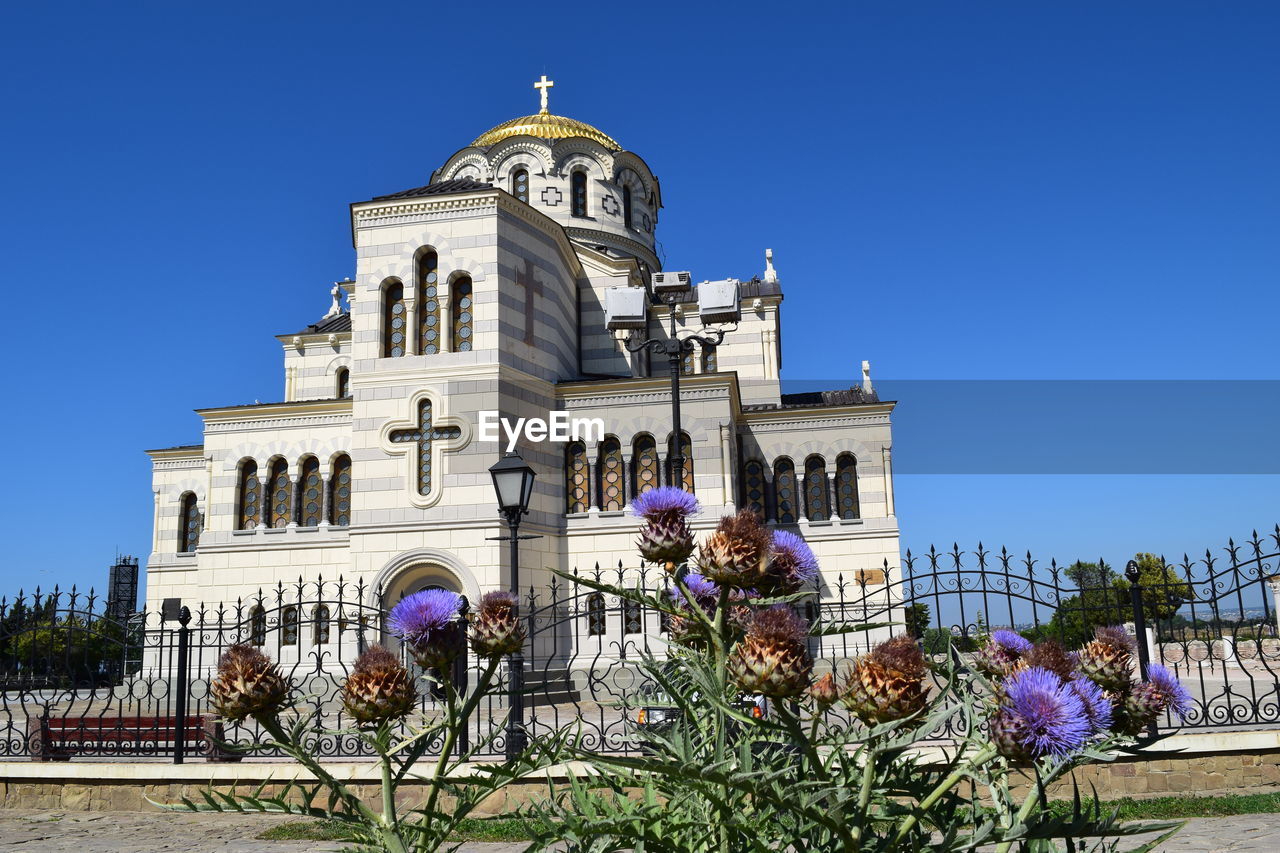 Low angle view of building against clear blue sky