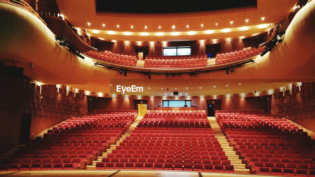 View of red chairs in auditorium