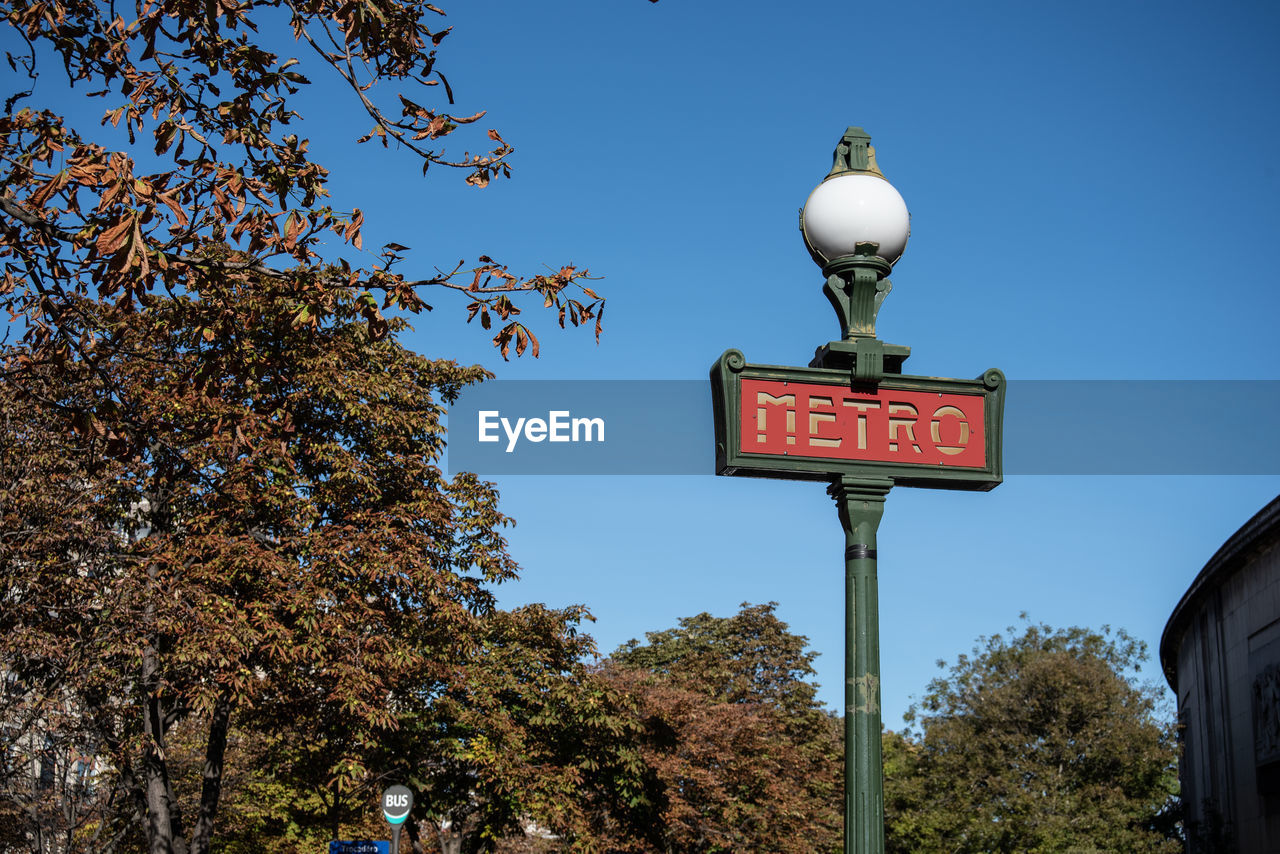 Low angle view of road sign against sky