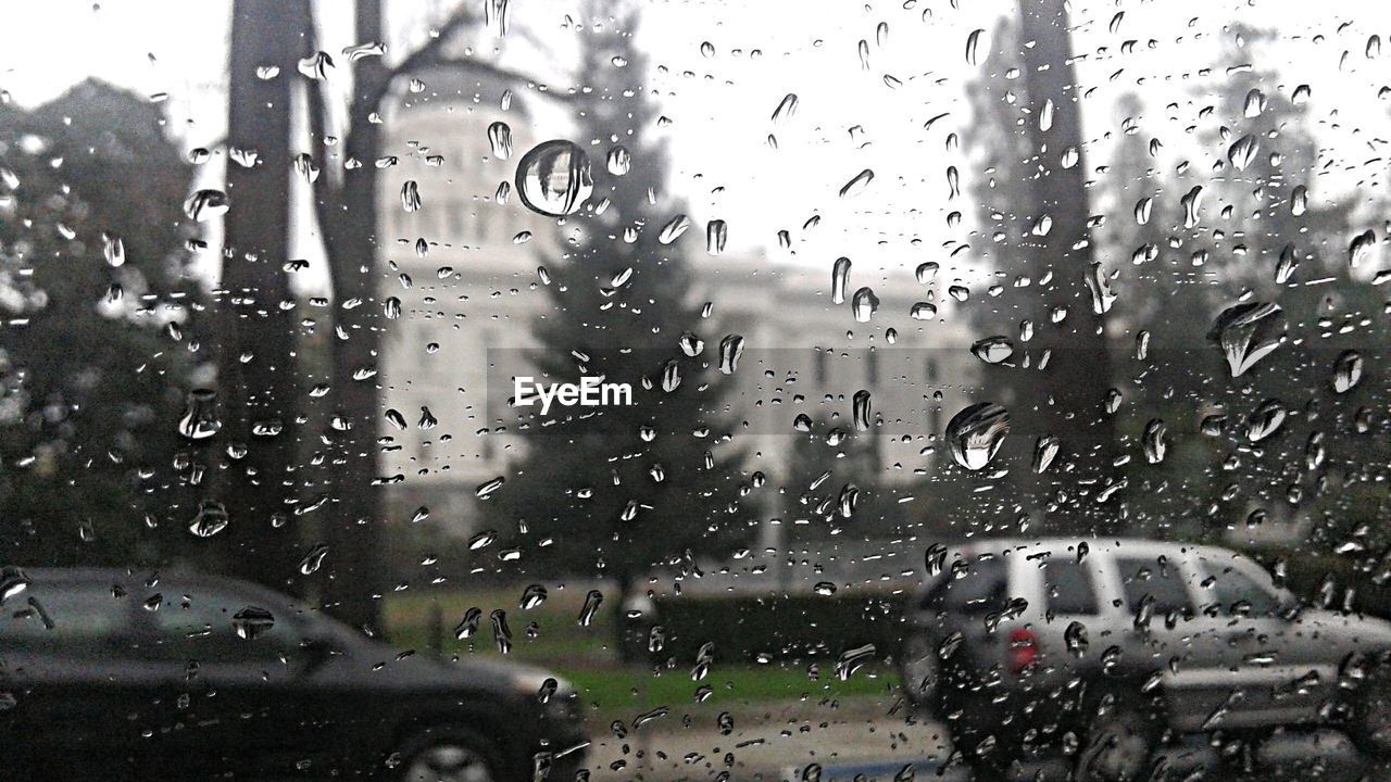 Cars on road seen through wet window