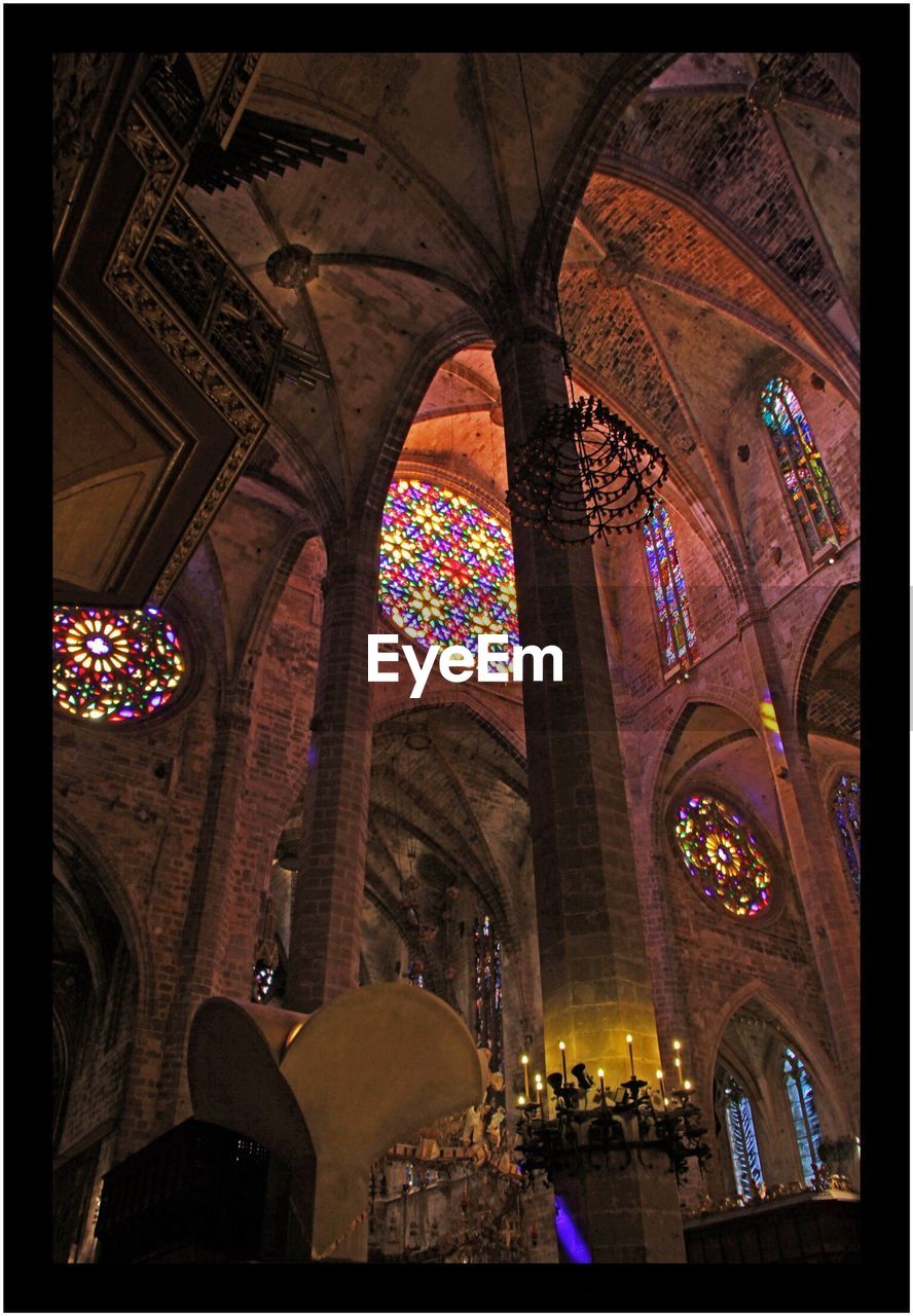 LOW ANGLE VIEW OF ILLUMINATED CEILING OF CATHEDRAL