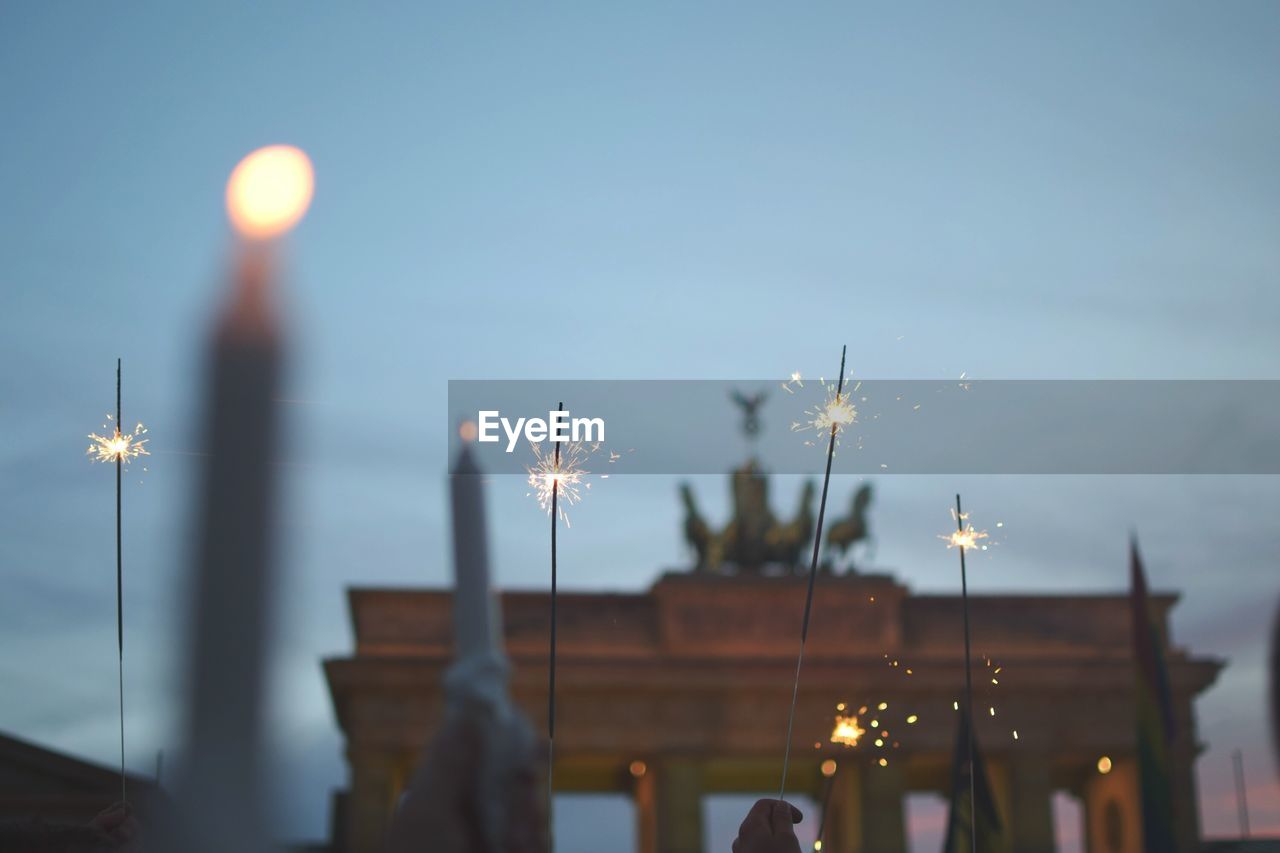 Low angle view of candles and sparkles at brandenburg gate