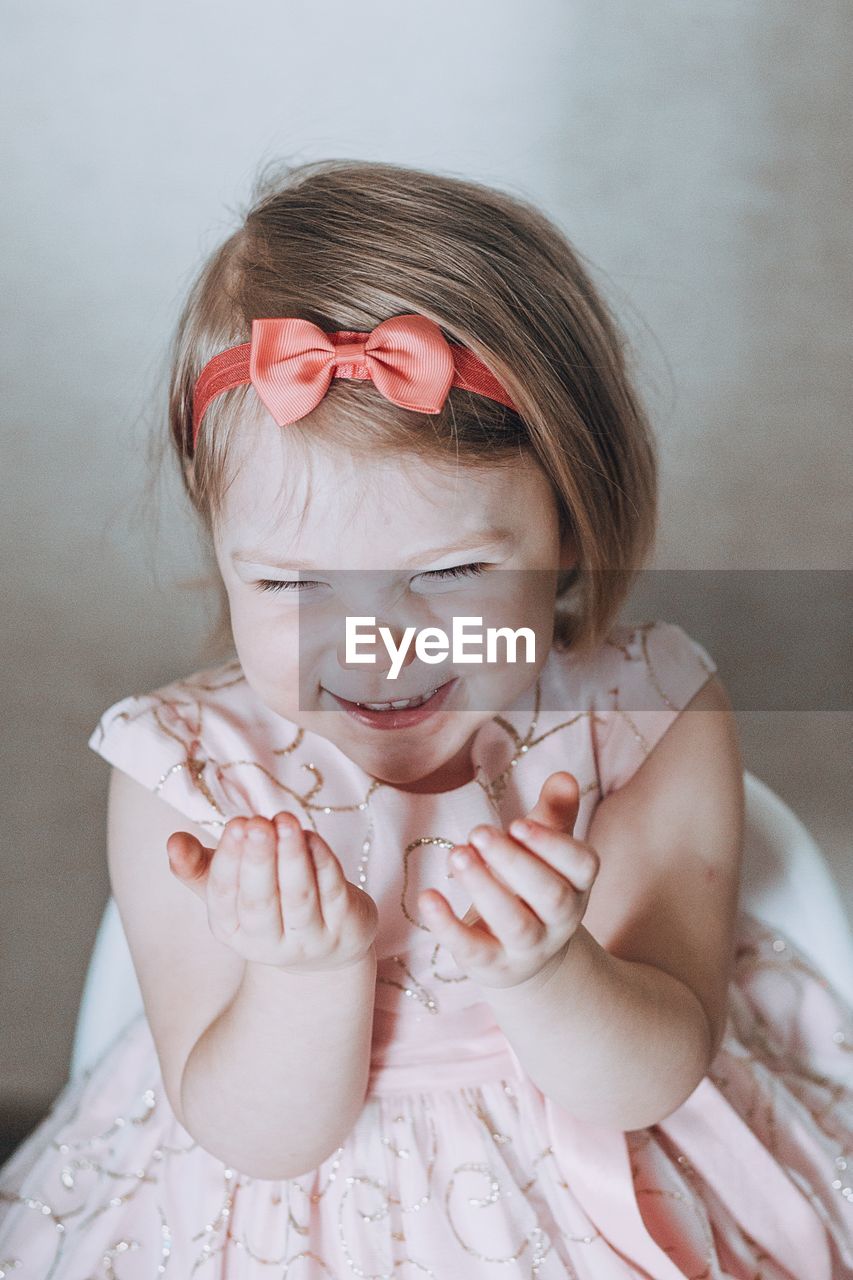 Smiling girl in dress at home