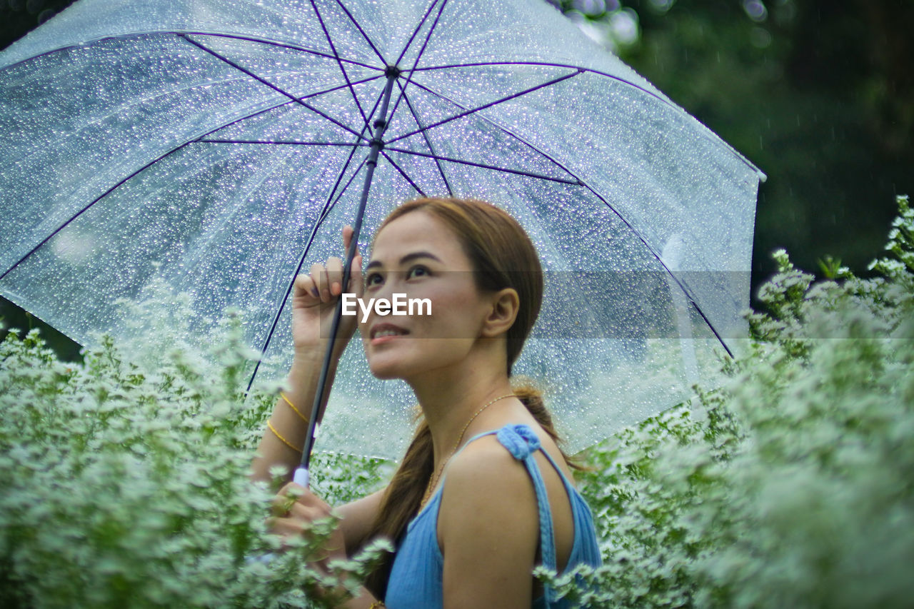 Portrait of woman standing on wet rainy day