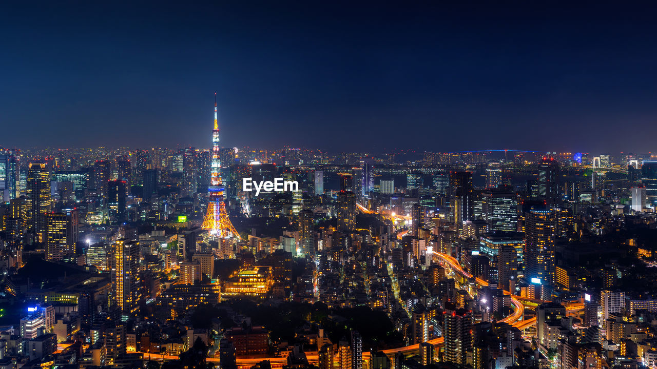 High angle view of illuminated city buildings at night