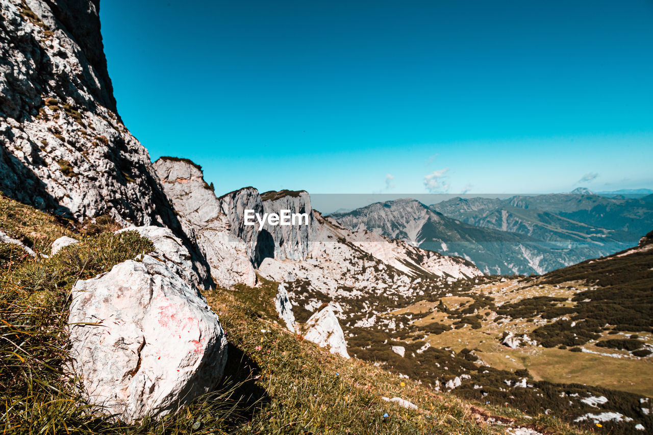 SCENIC VIEW OF MOUNTAINS AGAINST BLUE SKY