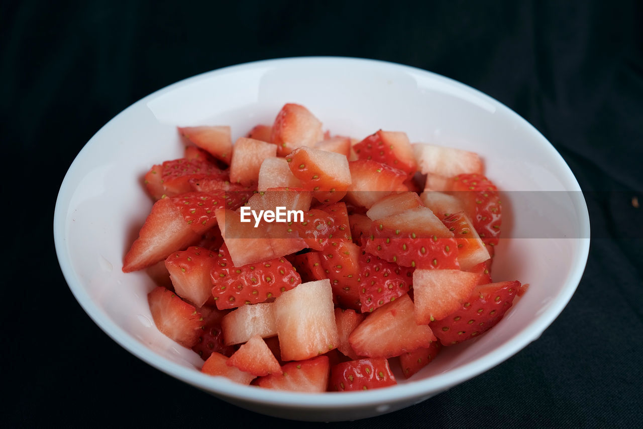 food and drink, food, healthy eating, plant, freshness, strawberry, fruit, produce, wellbeing, bowl, indoors, no people, dish, black background, watermelon, plate, melon, high angle view, meal, slice, studio shot, still life