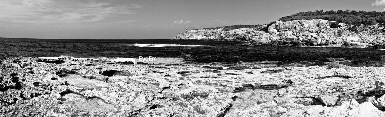 Rocks on beach against sky