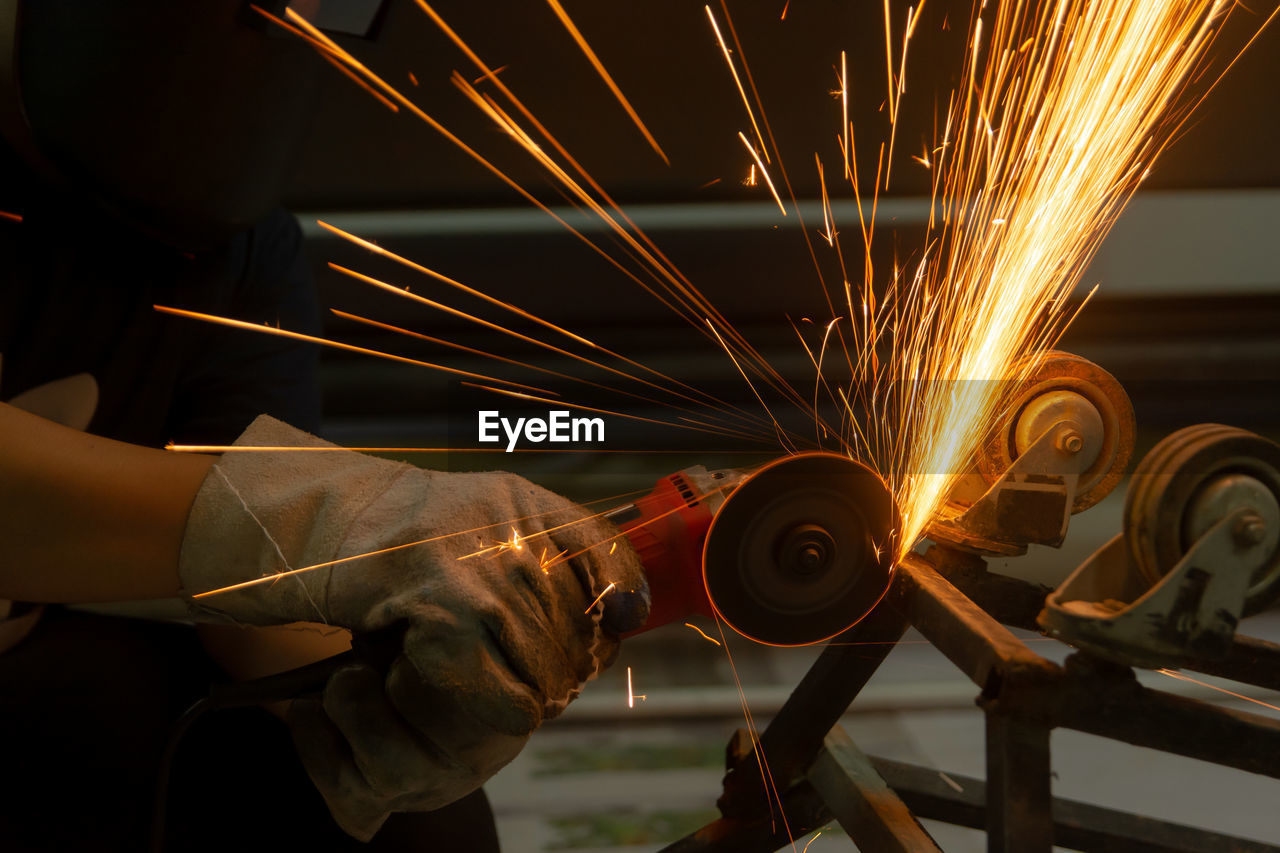 LOW ANGLE VIEW OF MAN WORKING AT NIGHT