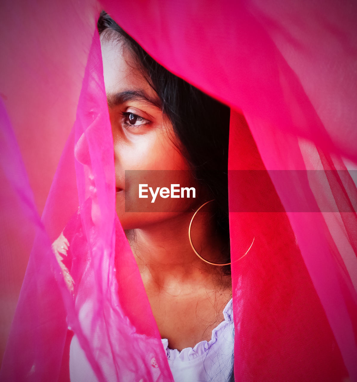 Close-up of girl seen through textile