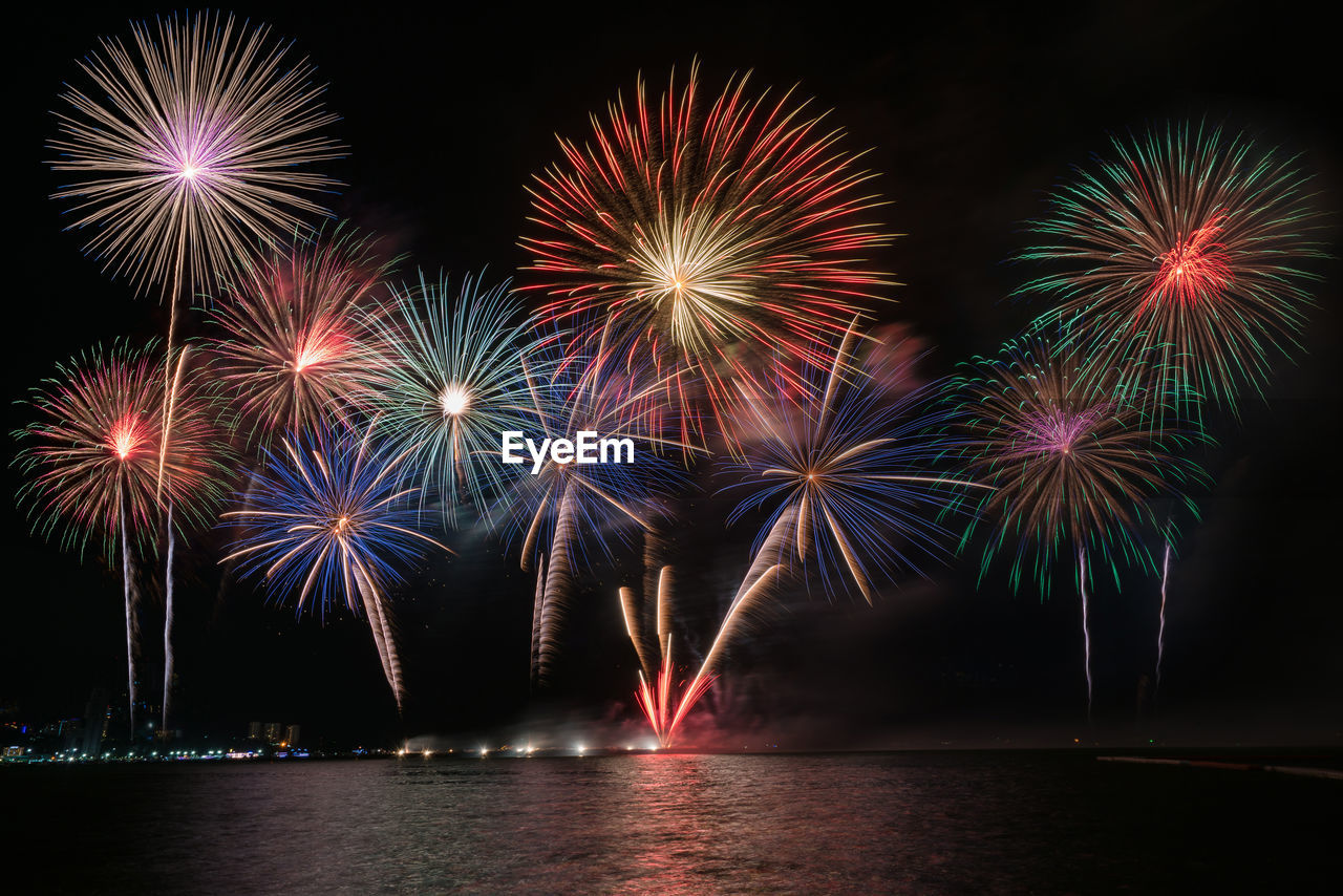 Firework display over river at night