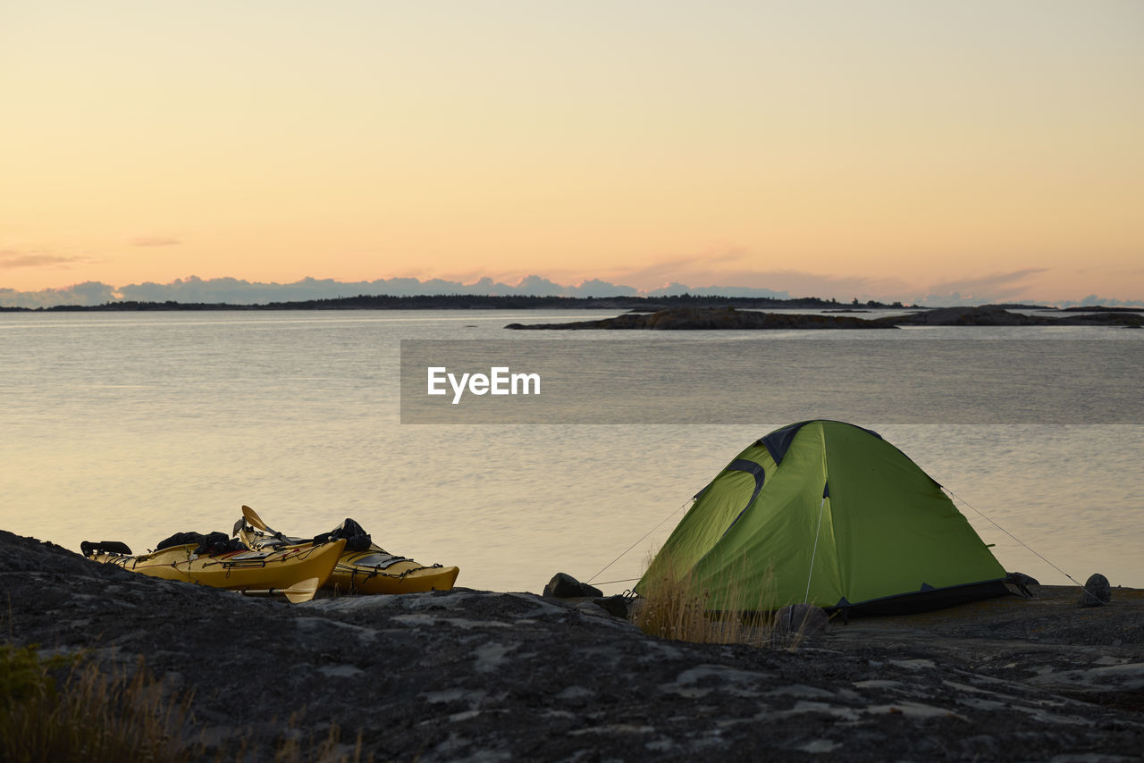 View of tent at rocky coast