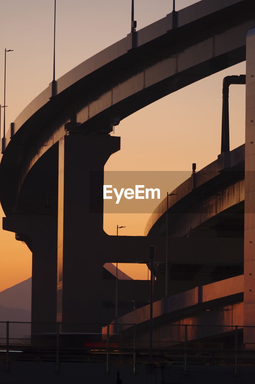 Low angle view of bridge against sky during sunset