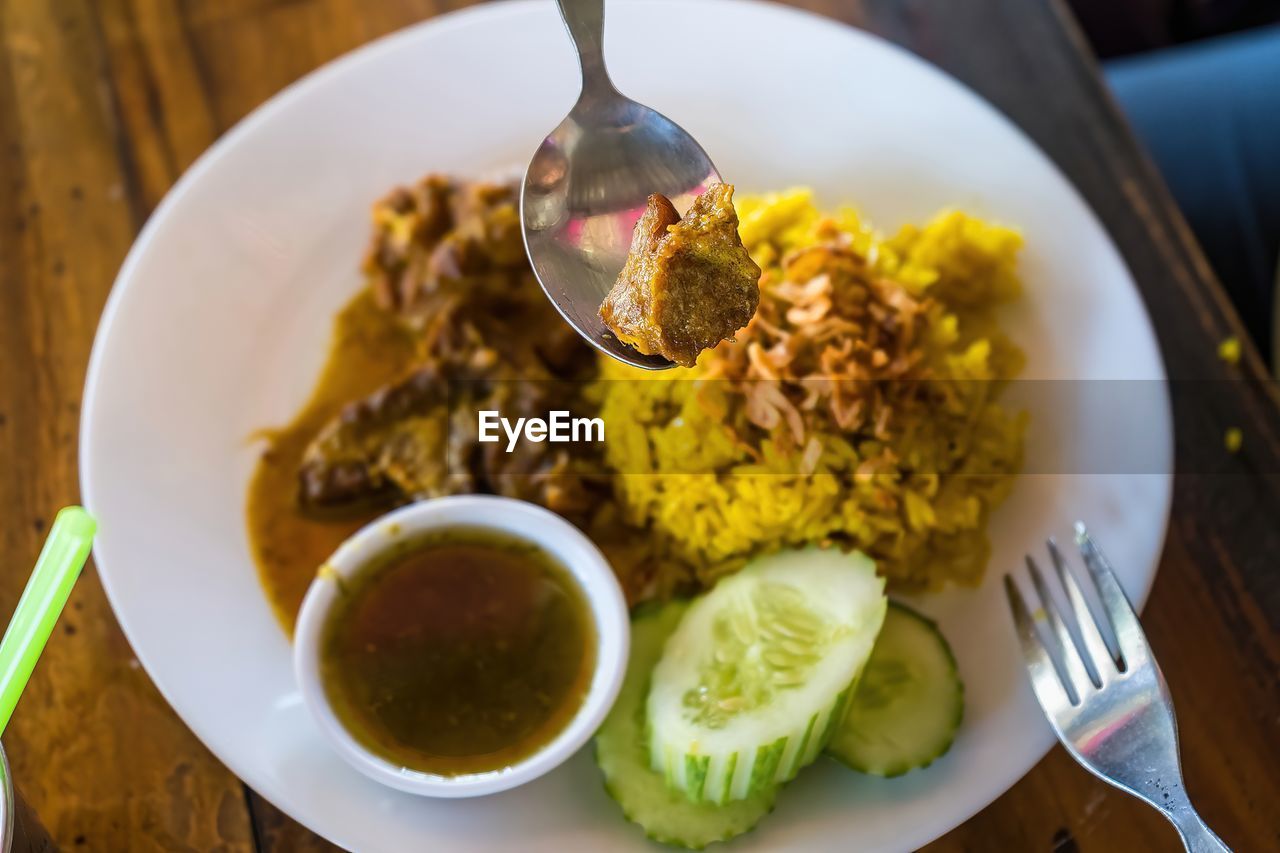 food and drink, food, eating utensil, kitchen utensil, healthy eating, dish, plate, freshness, wellbeing, meal, curry, spoon, table, fork, indoors, cuisine, no people, wood, asian food, produce, biryani, vegetable, fruit, indian food, high angle view, bowl, vegetarian food, breakfast, close-up, rice