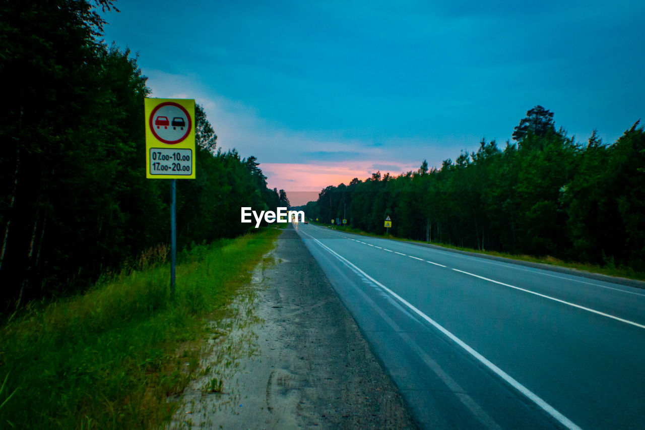 ROAD SIGN BY TREES