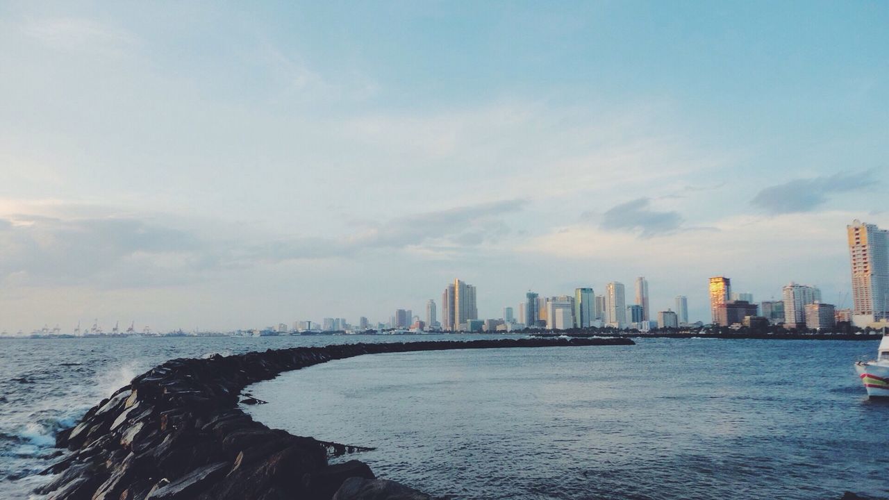 Sea with buildings in background