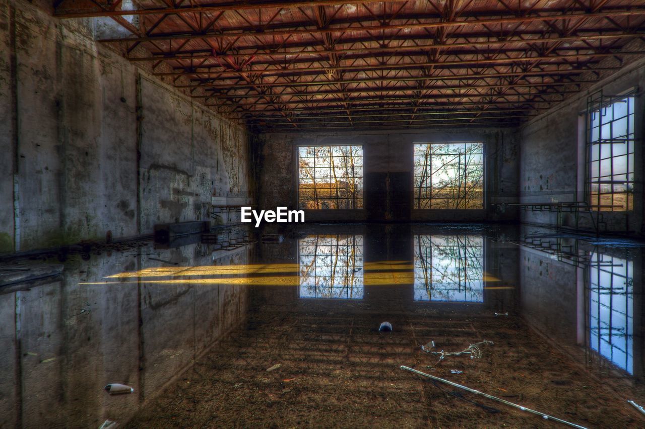 Interior reflecting on water in abandoned warehouse