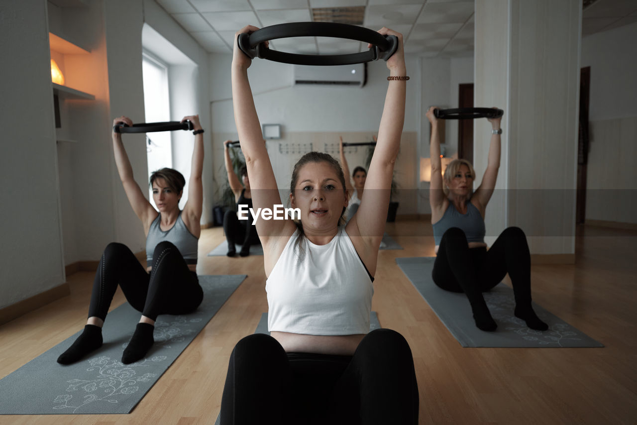 Group of women practicing pilates exercises in class