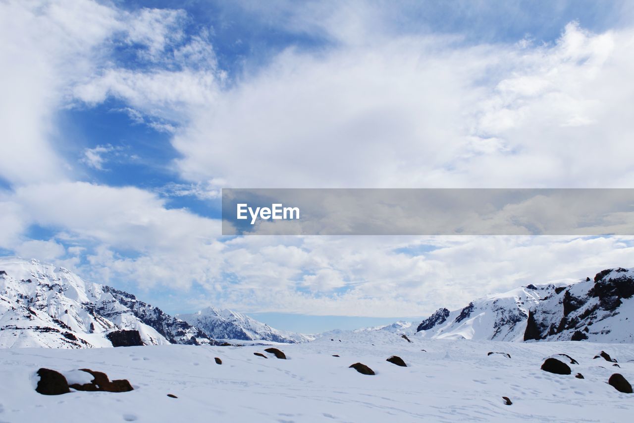 Scenic view of snowcapped mountains against sky