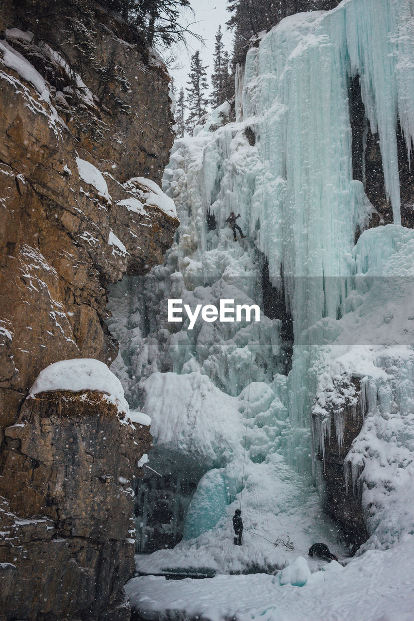 FROZEN WATERFALL ON LAND DURING WINTER