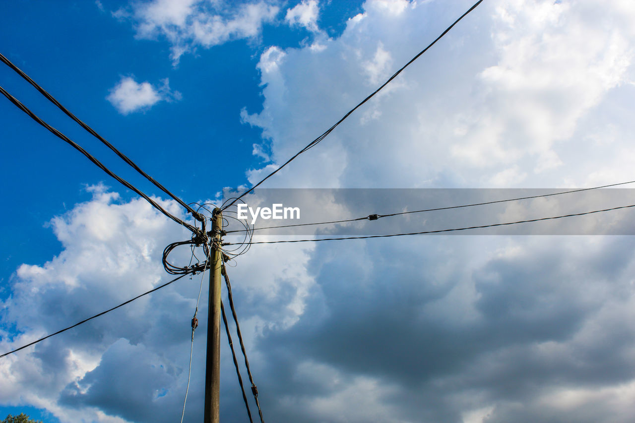 Low angle view of power lines against sky