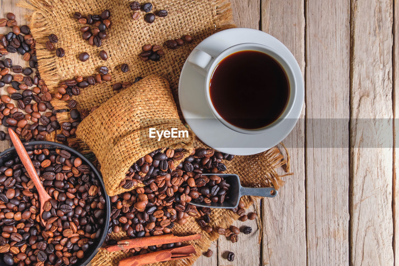 food and drink, coffee, drink, food, cup, roasted coffee bean, mug, refreshment, wood, freshness, hot drink, high angle view, table, coffee cup, black coffee, directly above, tea, indoors, no people, brown, still life, healthy eating, crockery, wellbeing, seed, spice, studio shot, masala chai, dried food, black tea, fruit