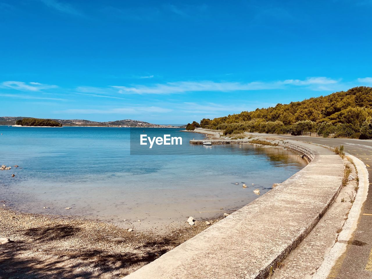 water, land, sea, sky, shore, beach, coast, body of water, scenics - nature, nature, ocean, beauty in nature, horizon, sand, tranquility, travel destinations, blue, tranquil scene, travel, coastline, vacation, landscape, environment, no people, tree, cloud, bay, day, tourism, outdoors, island, holiday, trip, wave, idyllic, sunlight, plant, summer, sunny, transportation, non-urban scene, clear sky, cove, mountain, lagoon, seascape, tropical climate, water's edge