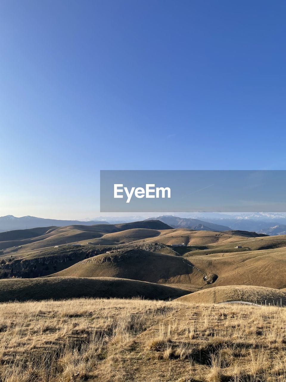 Scenic view of landscape against clear blue sky