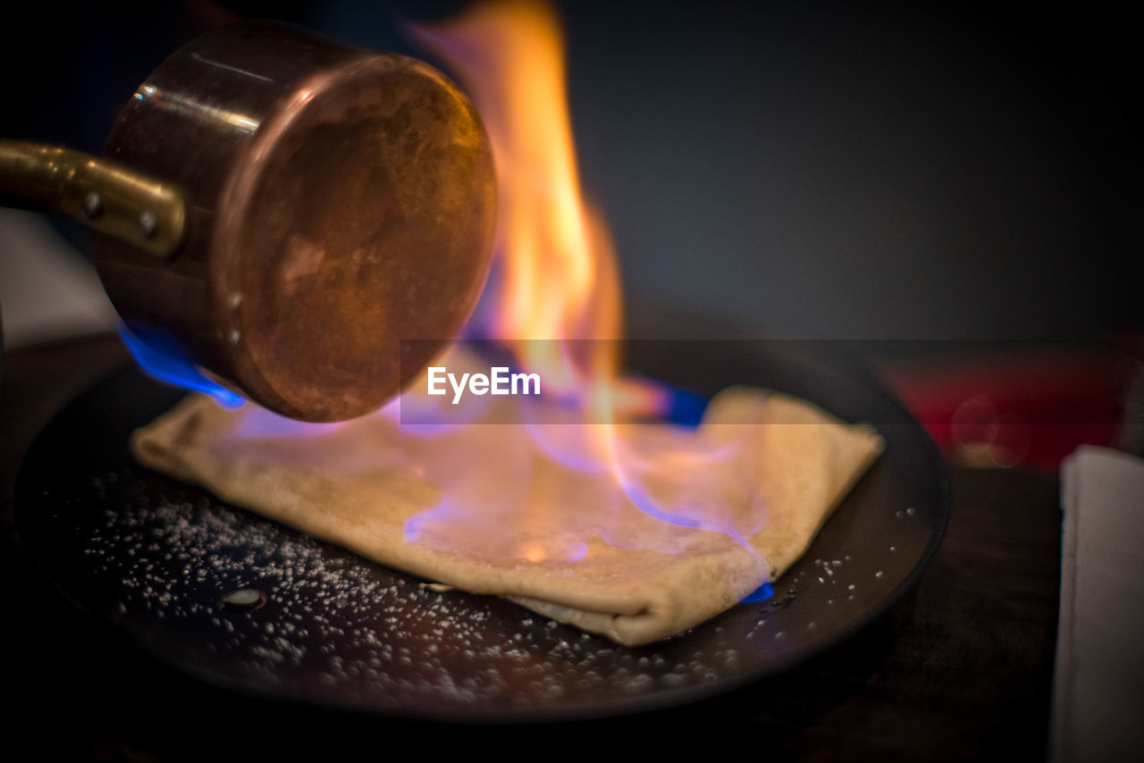 CLOSE-UP OF BURNING CANDLES ON BARBECUE