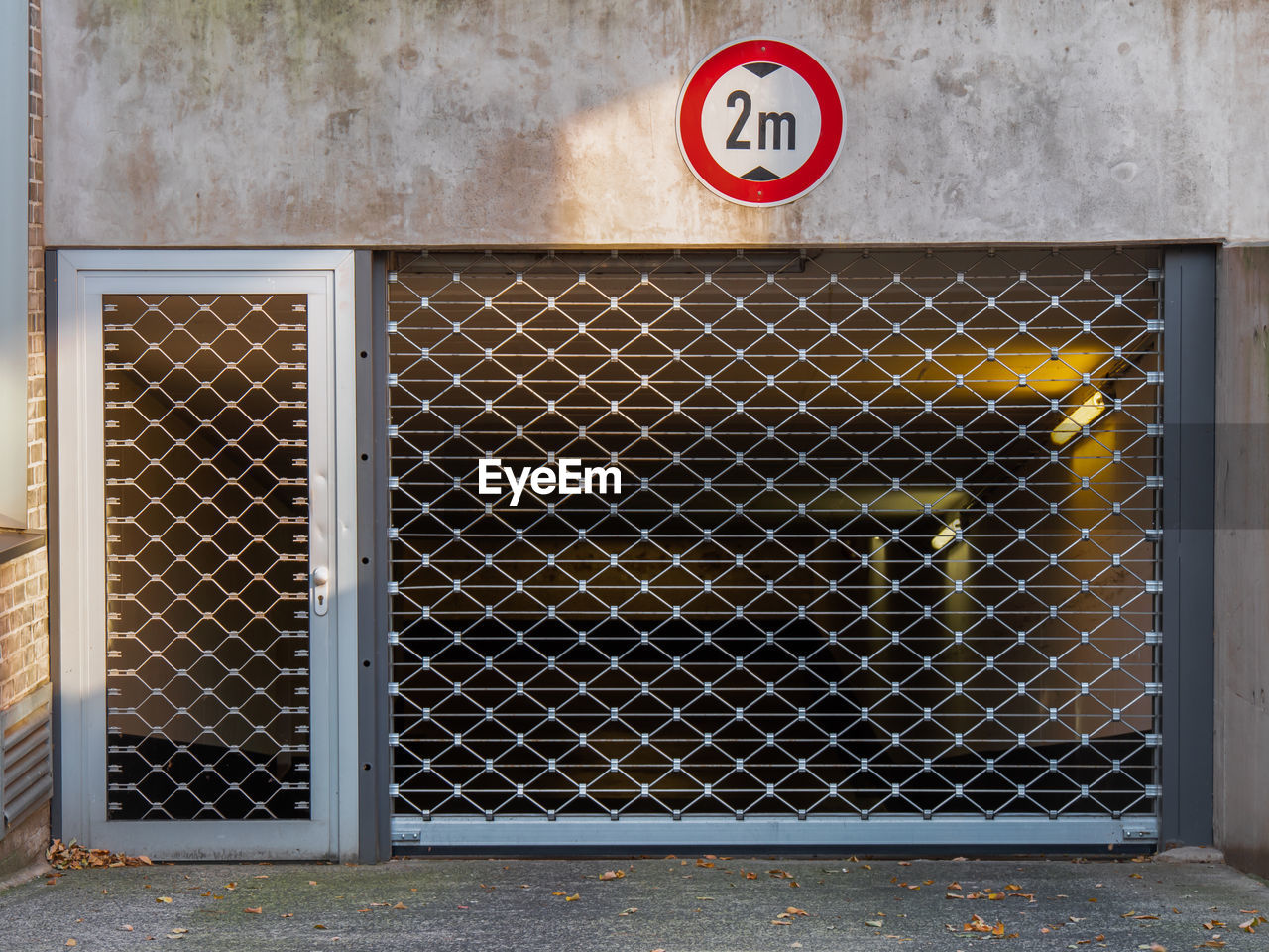 ROAD SIGN BY FENCE