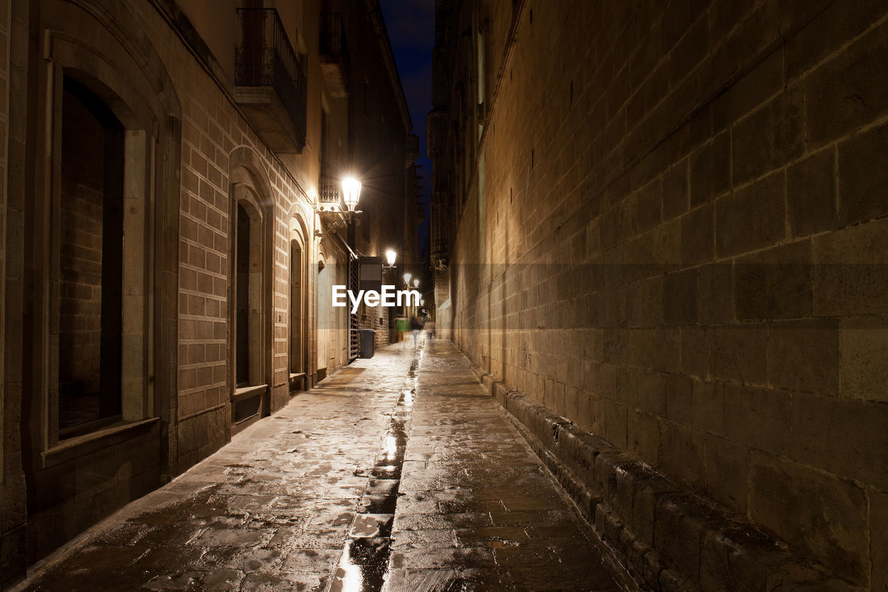 EMPTY NARROW ALLEY ALONG BUILDINGS