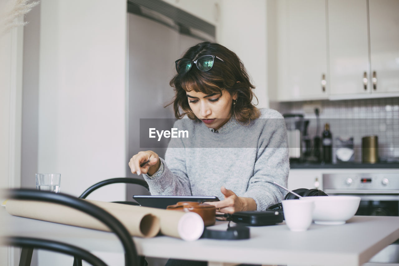 Woman reading on tablet working from home