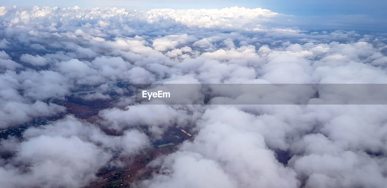 AERIAL VIEW OF CLOUDS COVERING MOUNTAINS