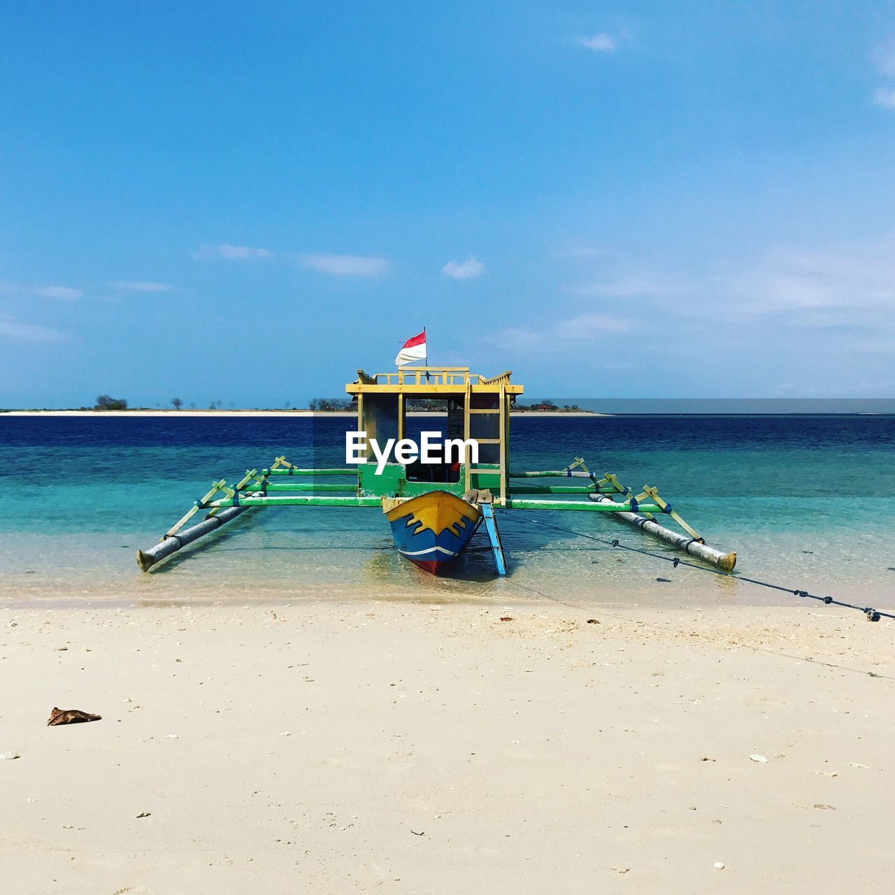 DECK CHAIRS ON BEACH AGAINST SKY