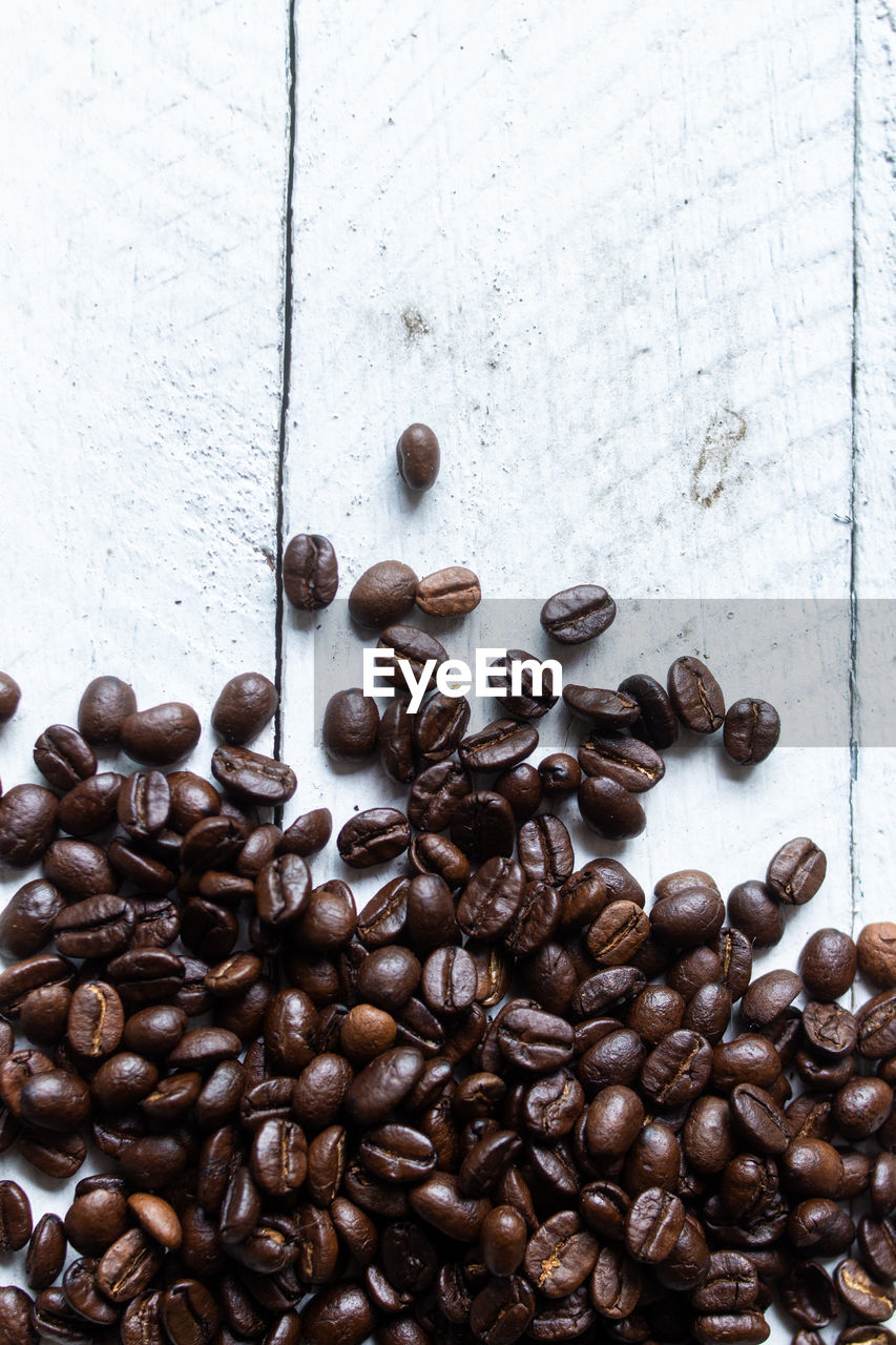 Coffee beans on the wood background