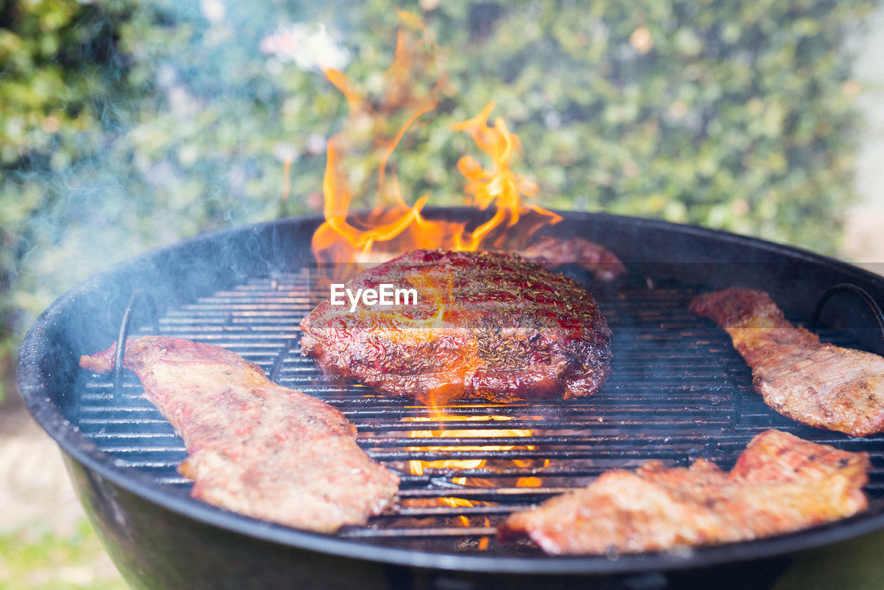 CLOSE-UP OF MEAT ON BARBECUE