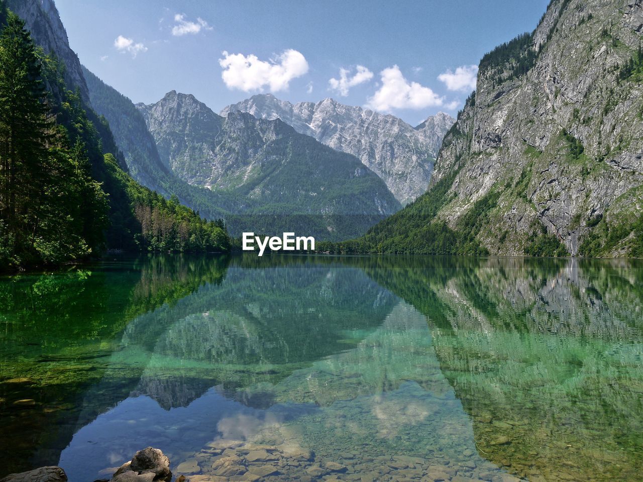 Scenic view of lake and mountains against sky