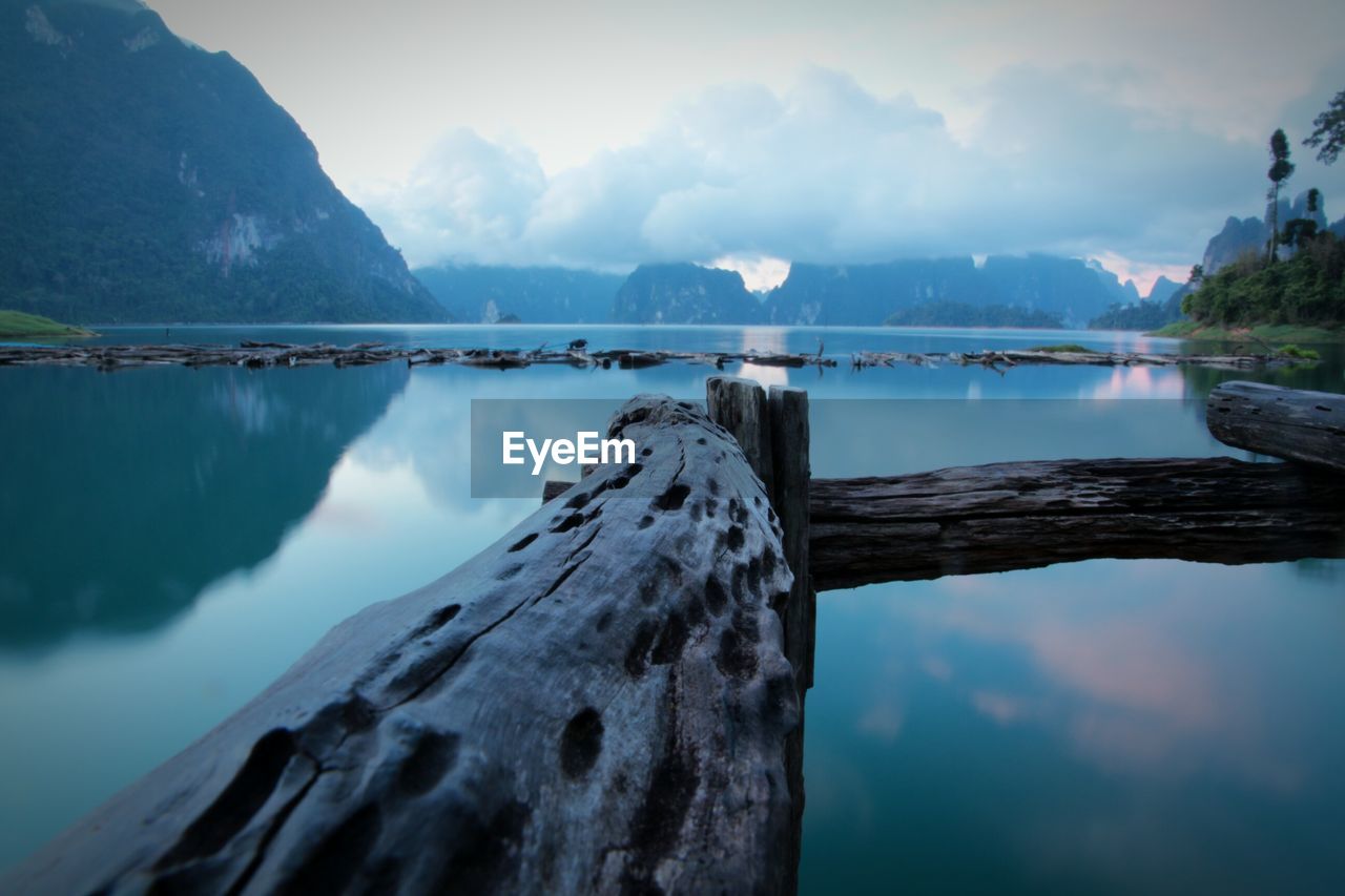 Scenic view of lake by mountains against sky