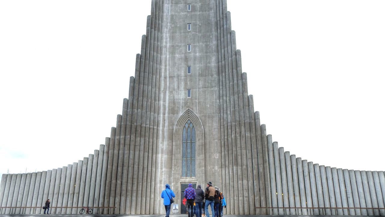 Rear view of people at hallgrímskirkja against clear sky