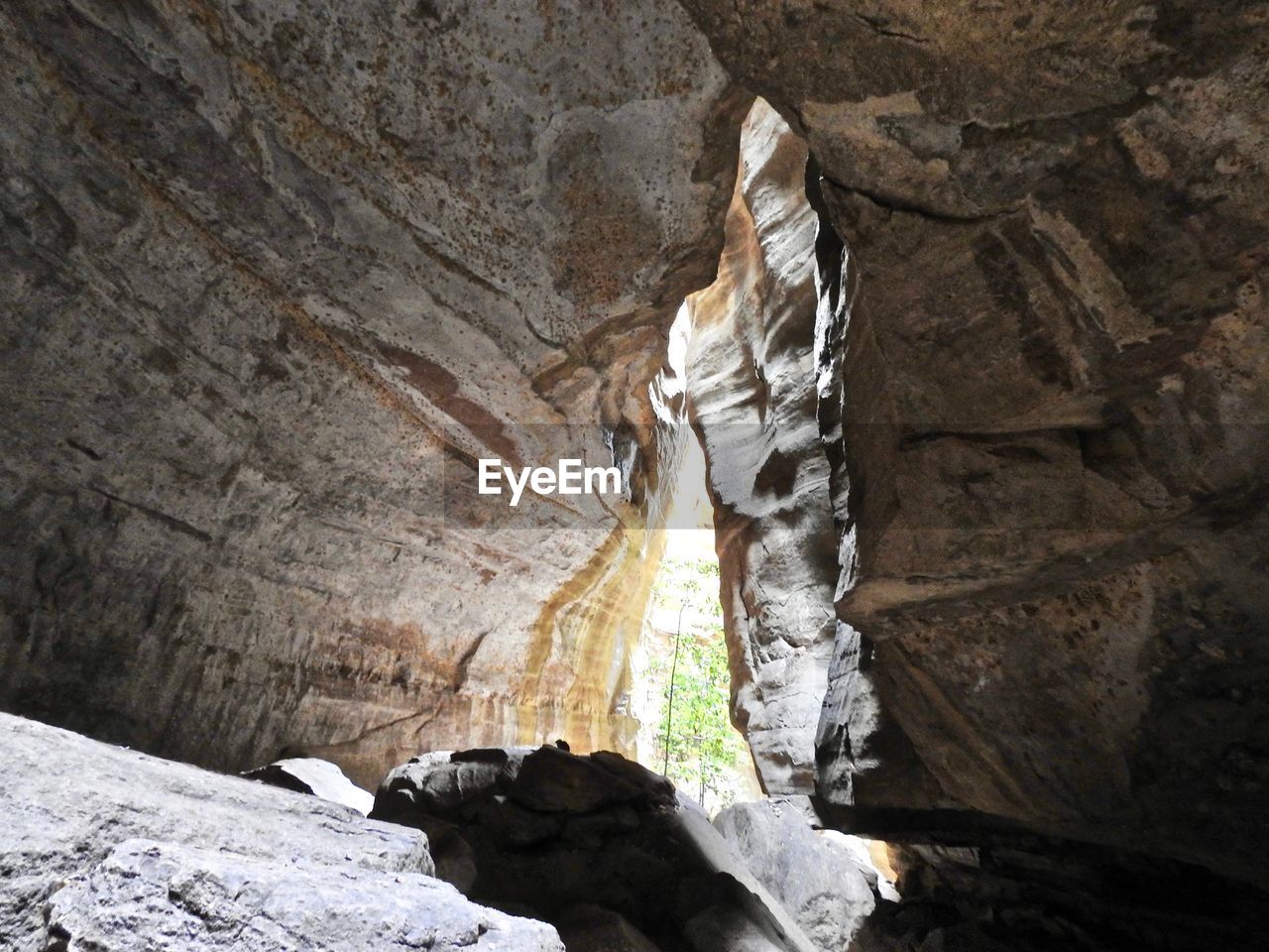 LOW ANGLE VIEW OF ROCK FORMATIONS IN CAVE