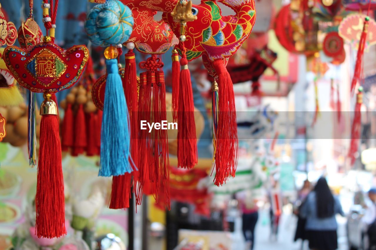 Close-up of souvenirs hanging at market stall