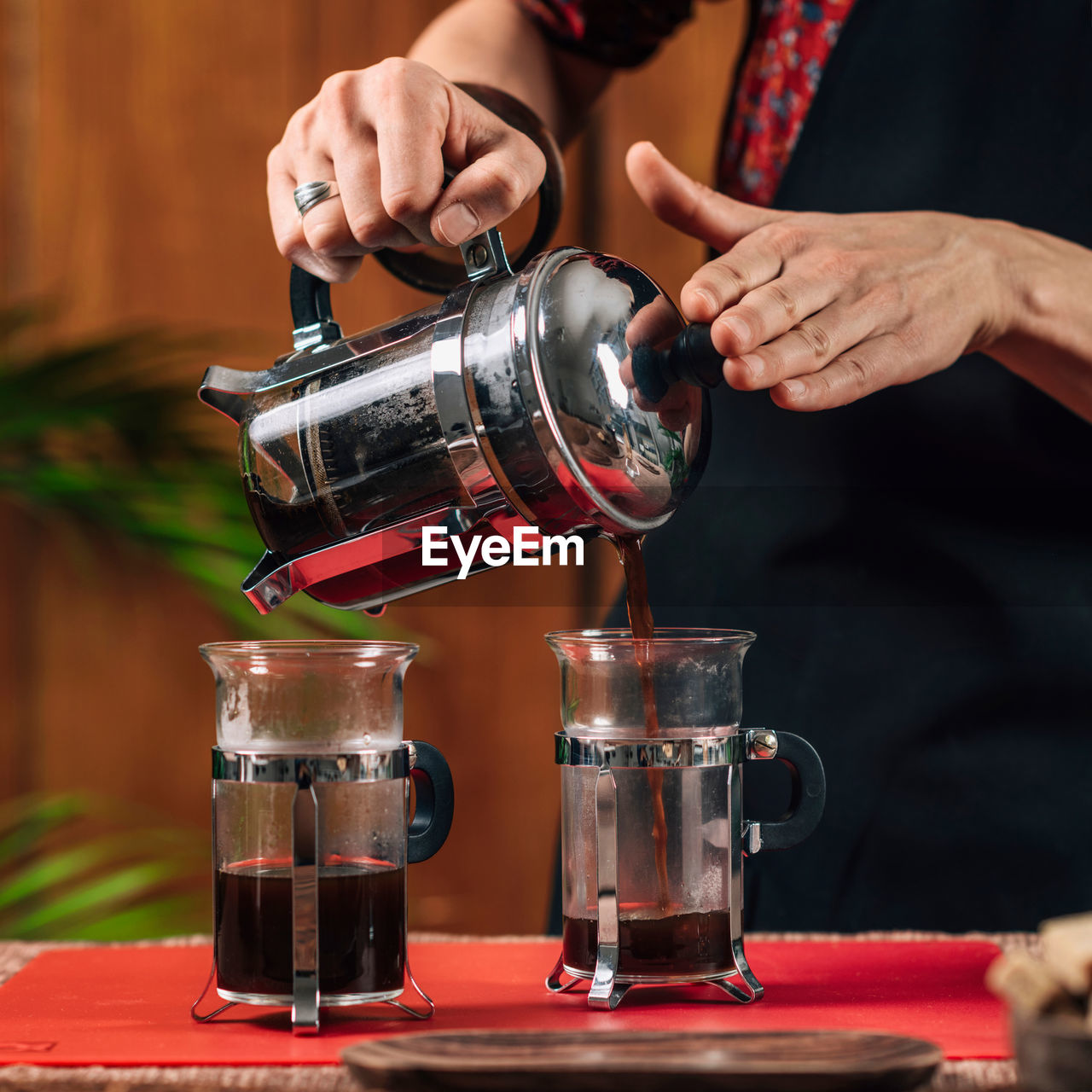 Midsection of woman making coffee in cafe