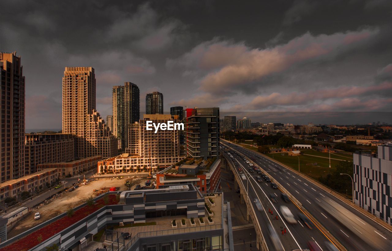 High angle view of street amidst buildings against sky