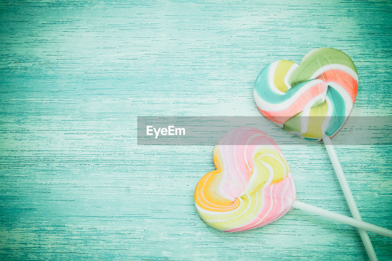 Close-up of colorful heart shape lollipops on table