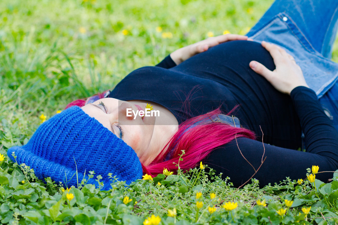 lying down, relaxation, plant, adult, grass, nature, one person, women, flower, lifestyles, flowering plant, young adult, leisure activity, eyes closed, field, person, lying on back, meadow, smiling, outdoors, tranquility, blue, resting, lawn, female, beauty in nature, clothing, summer, plain, casual clothing, portrait photography, wellbeing, springtime, emotion, day, land, happiness, three quarter length, green, freshness, yellow, tranquil scene, portrait