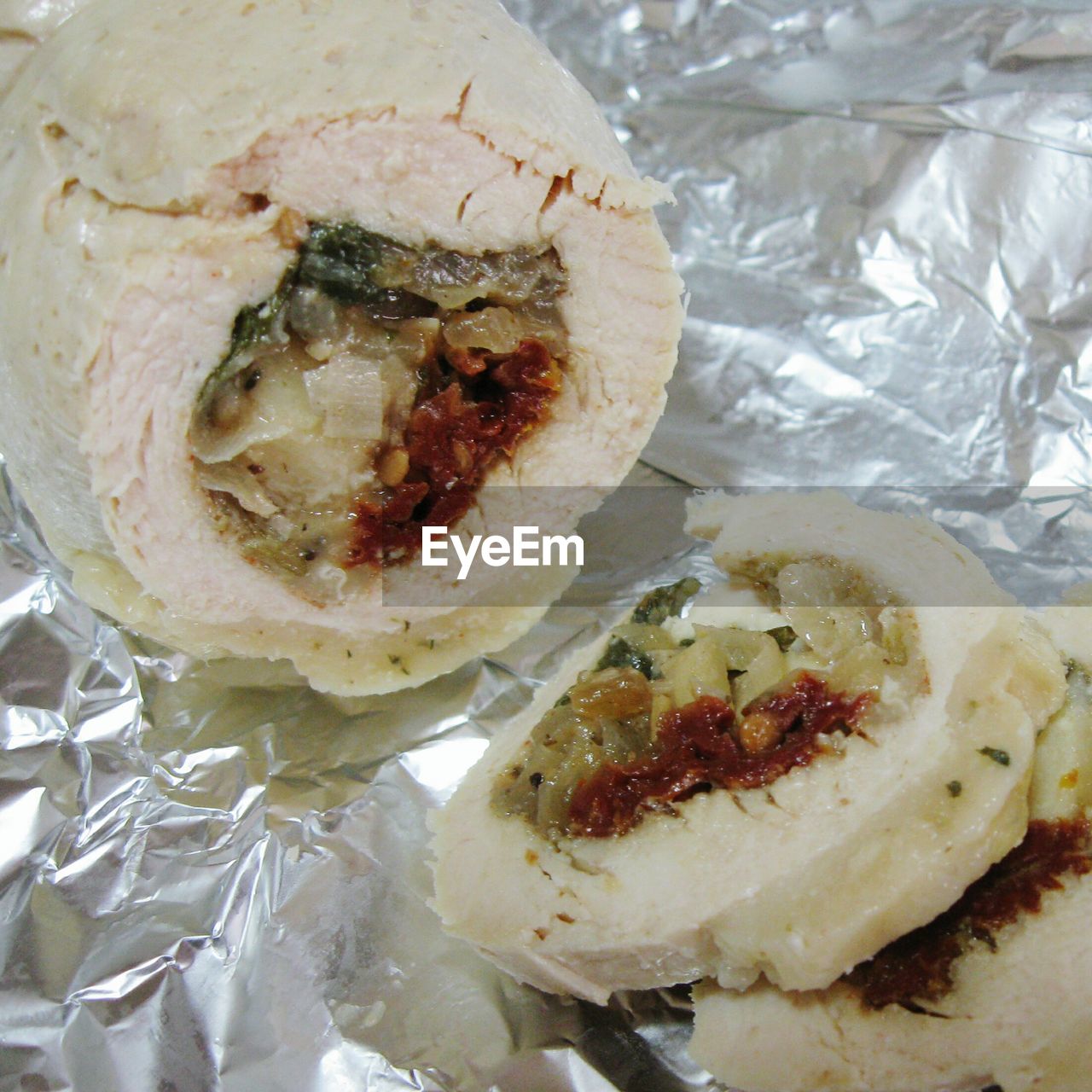 Close-up of rolled chicken stuffed with leeks on foil