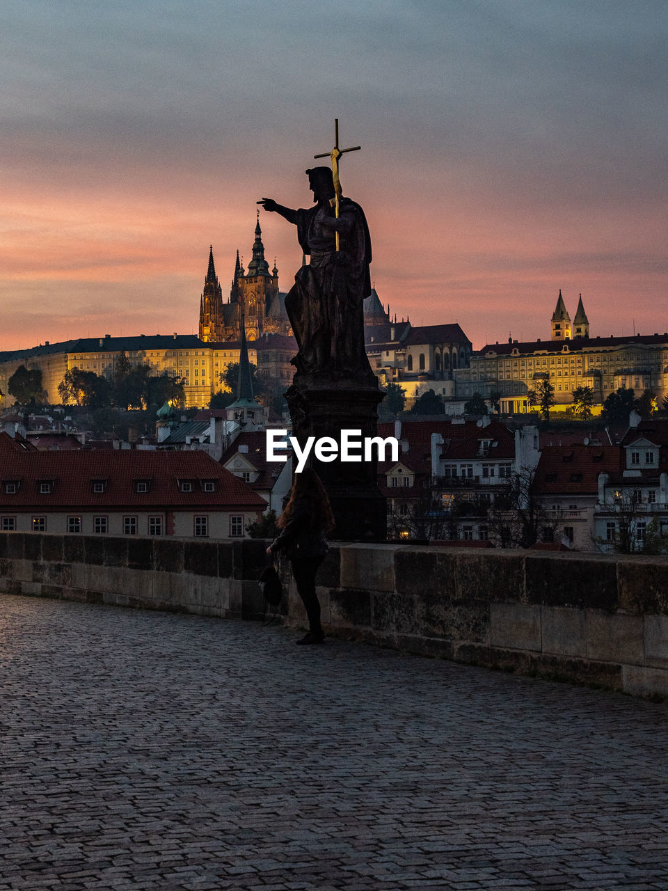 Statue on charles bridge in prague against sky during sunset